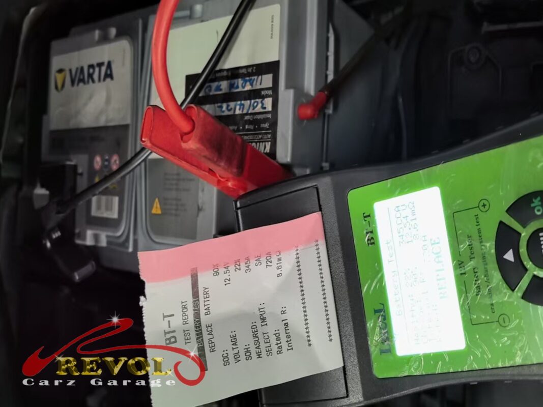 The load tester on the old VARTA battery, reading well below spec with a replace verdict.