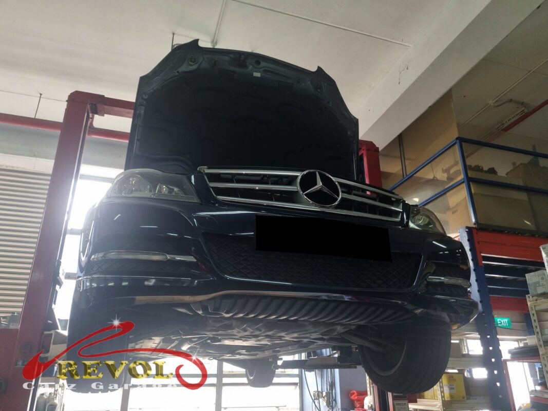 The C180 up on the two-post lift, hood open, in for its 10,000 km service.