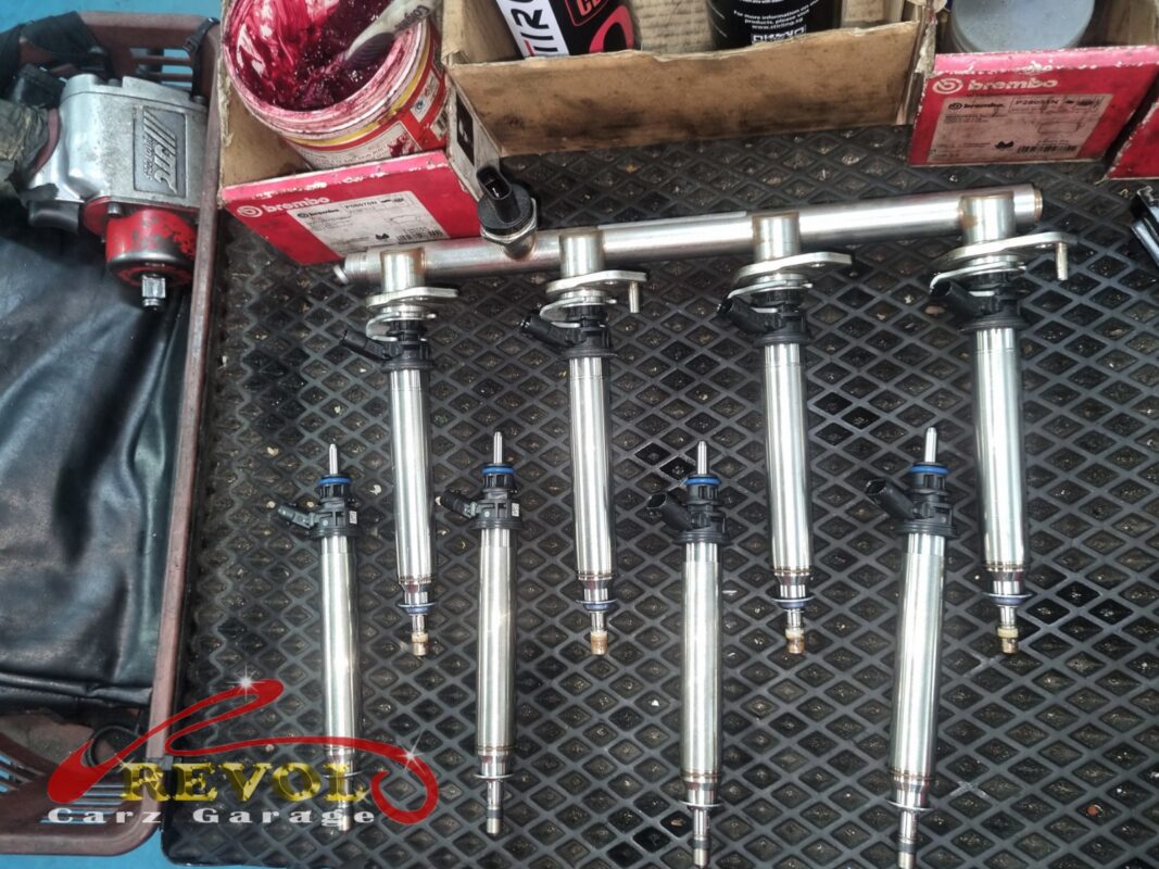 The fuel rail off, the old injectors out and laid out for the bench spray test.