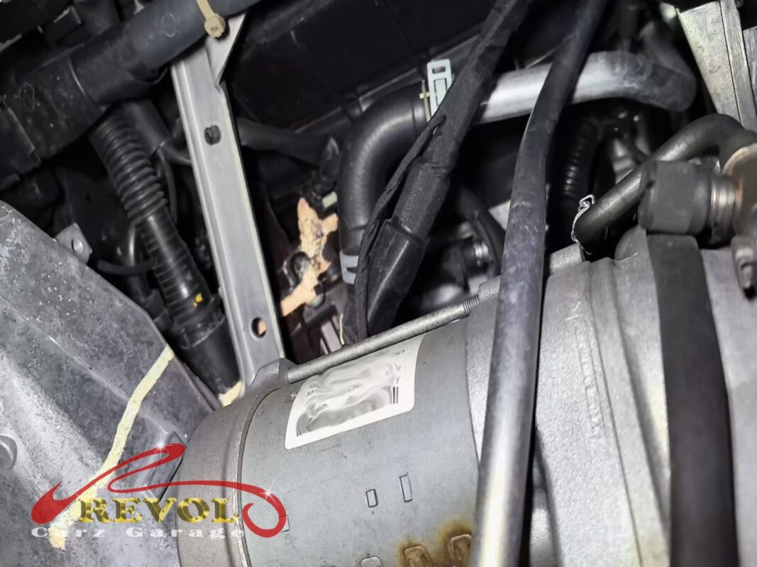 Coolant residue building in the engine bay where the cracked thermostat housing had been weeping.