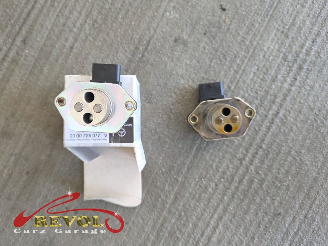 The old CAMTRONIC solenoid (right) beside the new Mercedes-spec replacement (left, in its box).