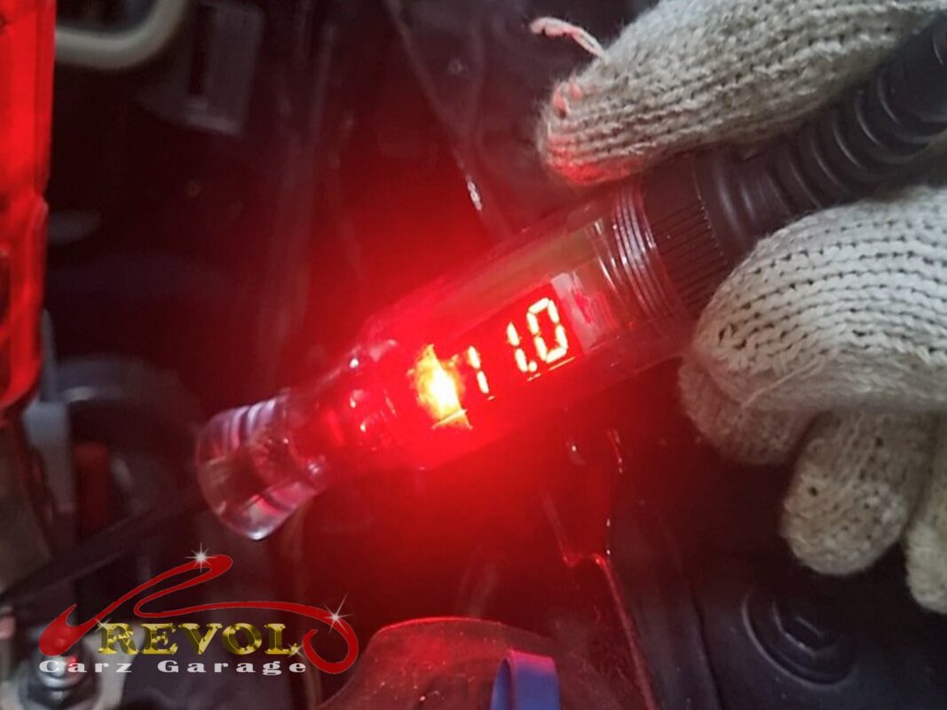 A voltage tester reading low at the battery, the charging system not keeping up.