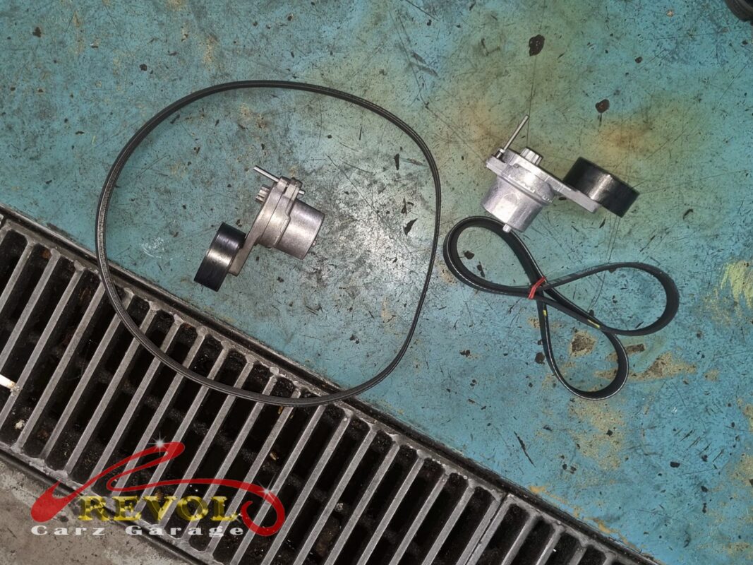The old serpentine belt and tensioner (left) beside the new Mercedes-spec belt and tensioner (right), done with the alternator.