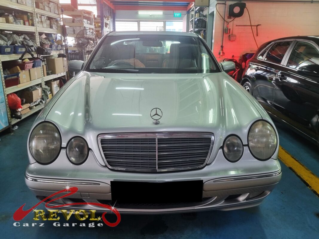 Mercedes-Benz E200 on the workshop lift with the gearbox separated for rear main seal access.
