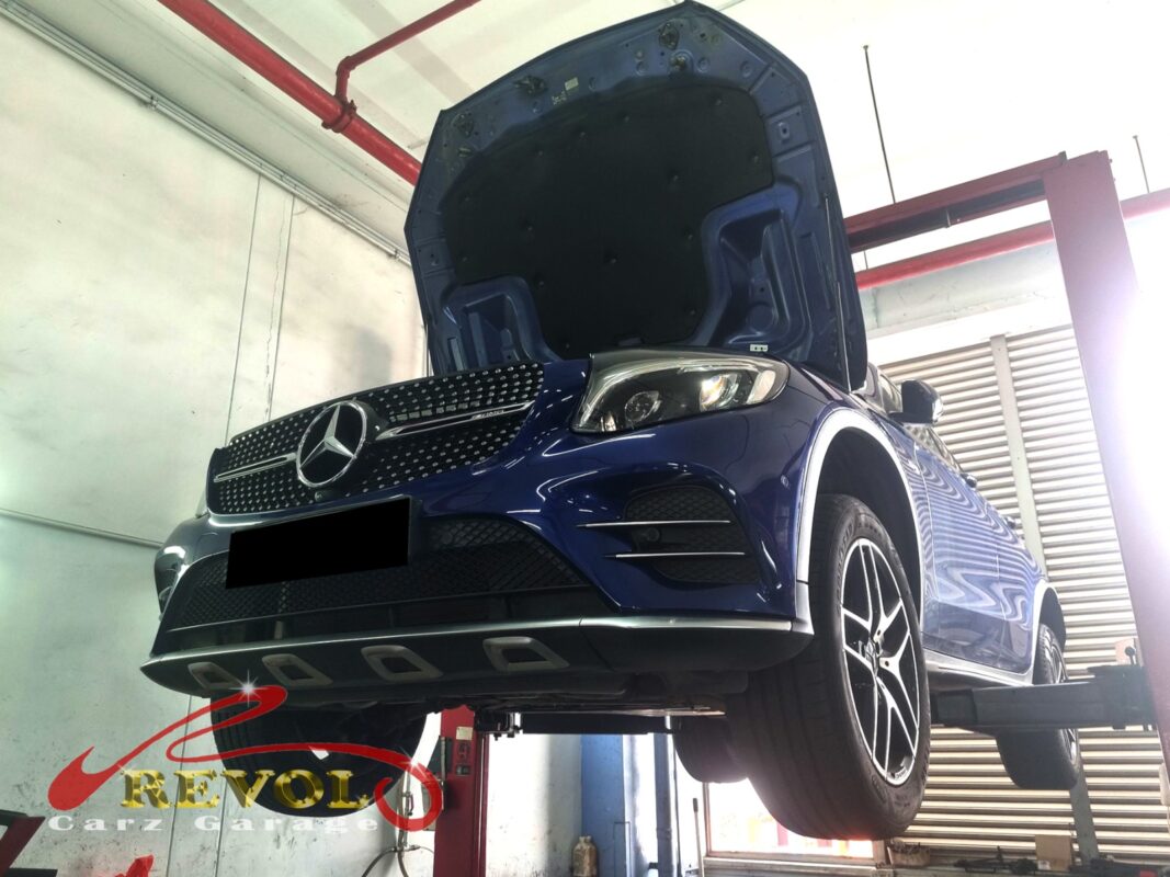 The GLC43 up on the two-post lift, hood open, in for the sagging suspension.