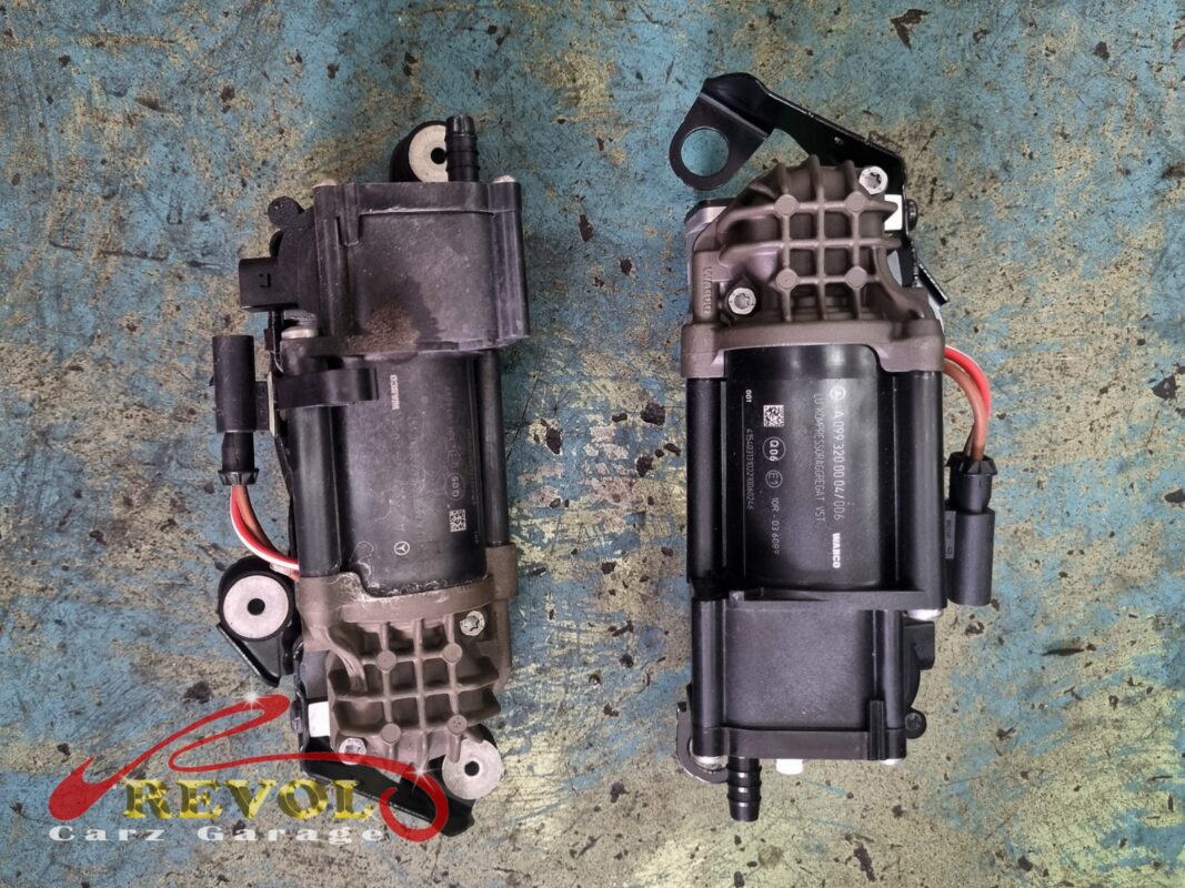 The old AIRMATIC air compressor (left) beside the new replacement (right), done with the struts.