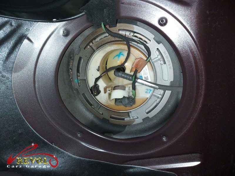 The access cover lifted on the Mercedes-Benz E250 to reach the in-tank fuel pump.