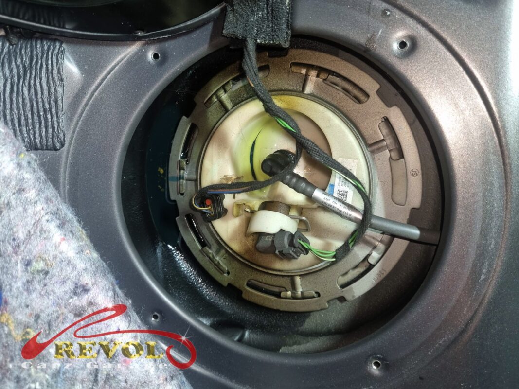 The in-tank fuel pump module exposed through the access hatch under the rear seat.