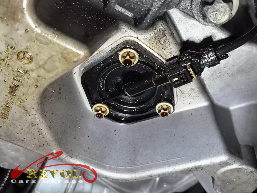 The oil level sensor bolted into the bottom of the engine sump.