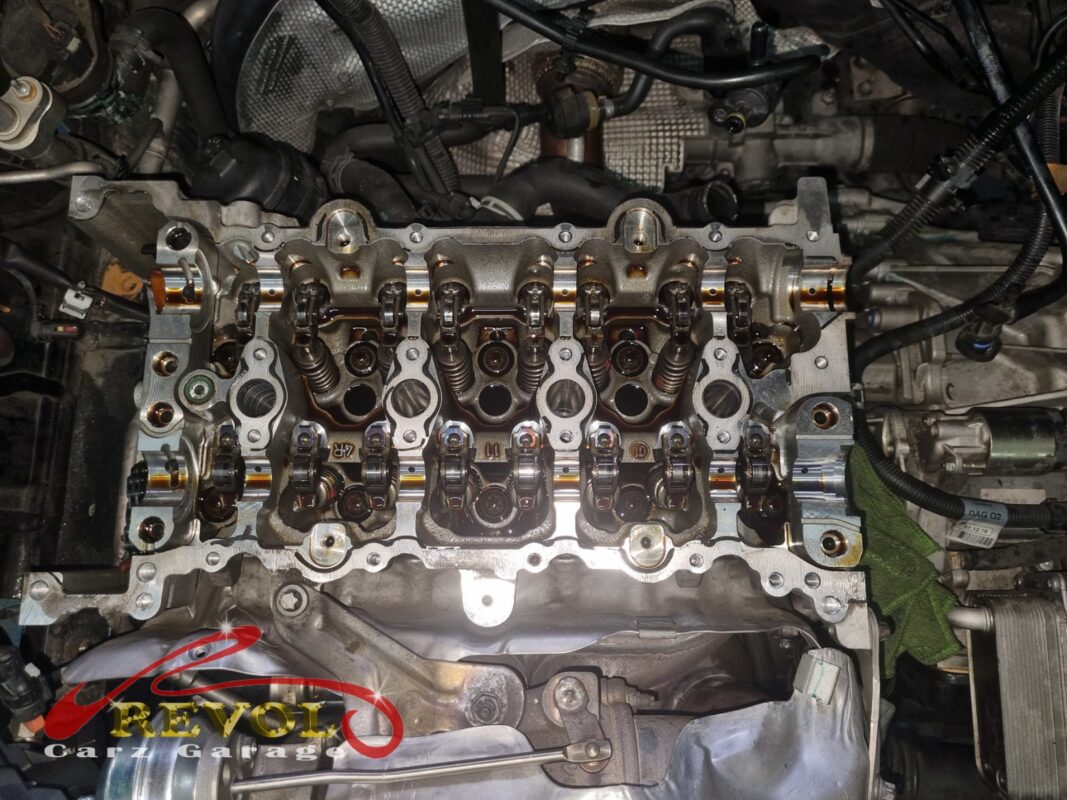 The cam cover off, the camshafts and rockers exposed for inspection.