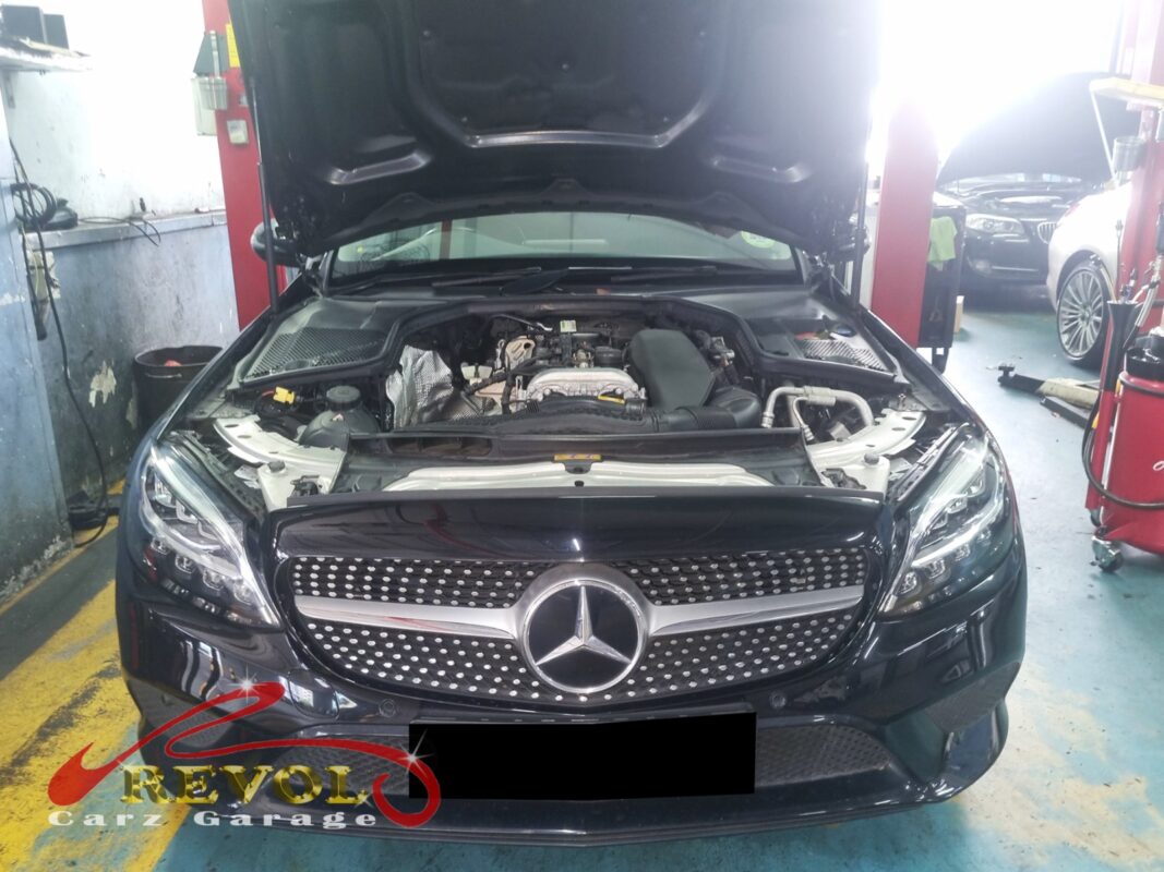 Mercedes-Benz C180 on the workshop lift for coolant leak diagnosis.