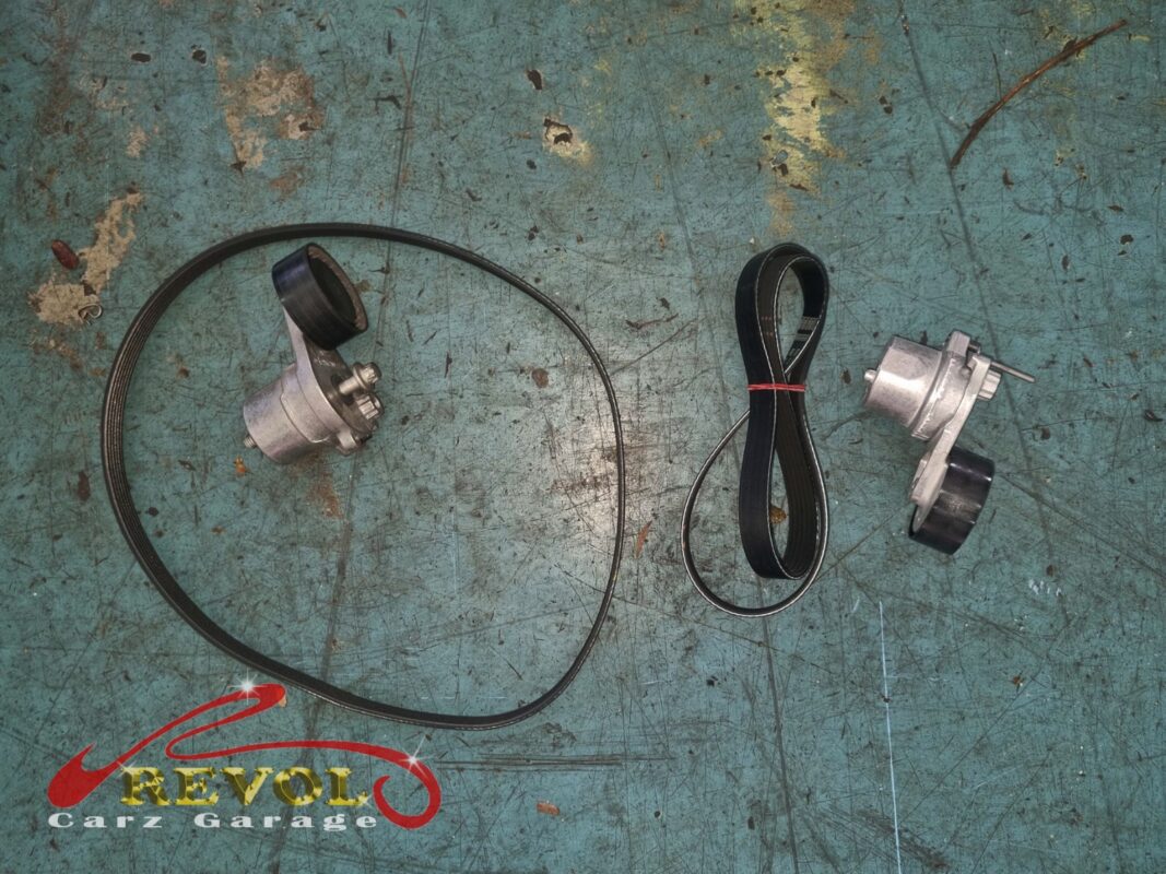 The old serpentine belt and tensioner (left) beside the new Mercedes-spec belt and tensioner (right), done with the alternator.
