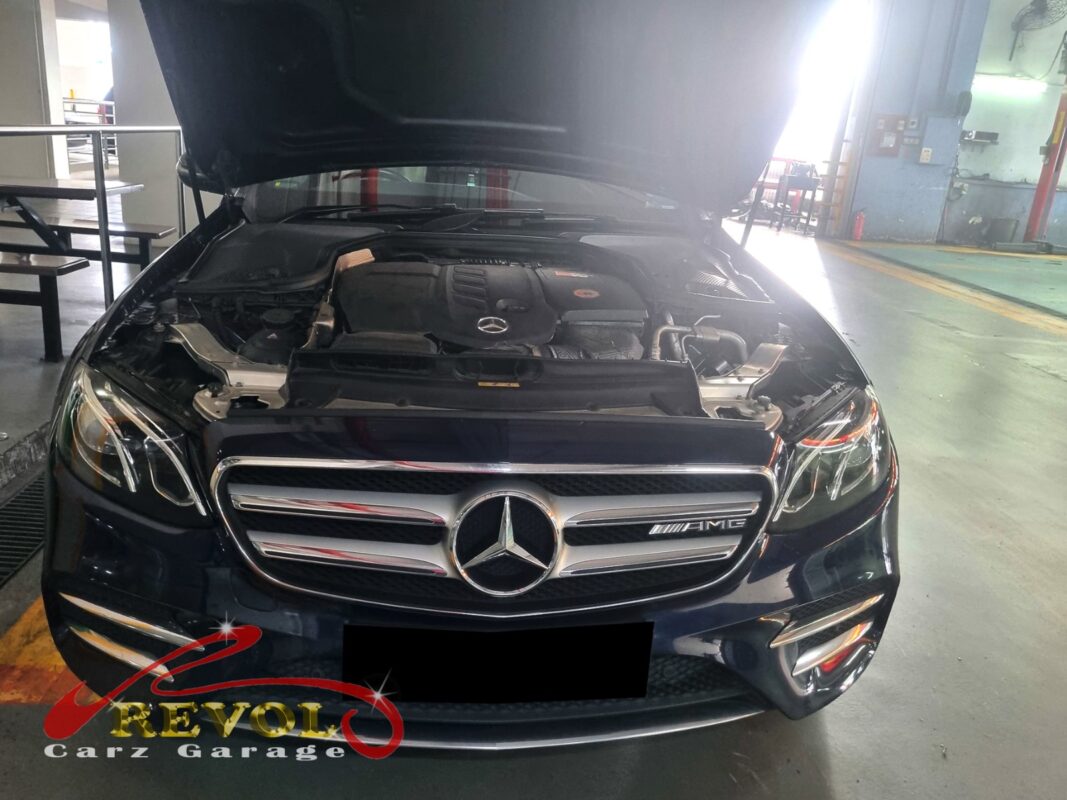 Mercedes-Benz E220d with the engine cover off for valve cover replacement.