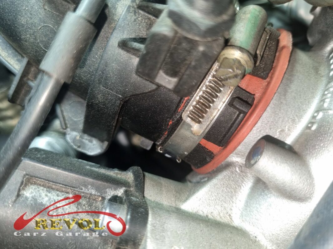 The turbo air hose on the engine, the split running along a fold where it flexes.