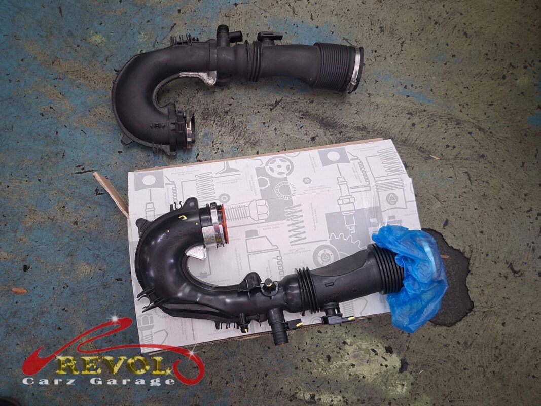 The old turbo air hose (top) beside the new Mercedes-spec replacement (bottom).