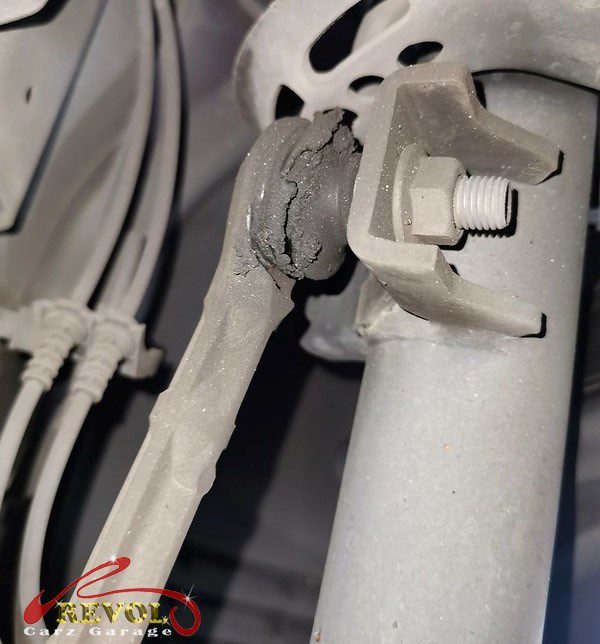 The old worn anti-roll bar links removed, ball joints loose.