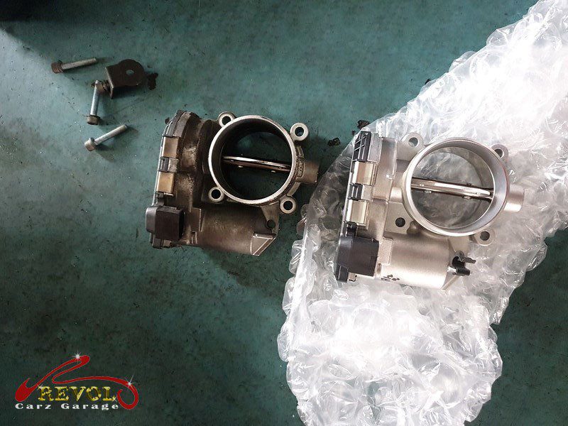 The old throttle body removed from the intake.