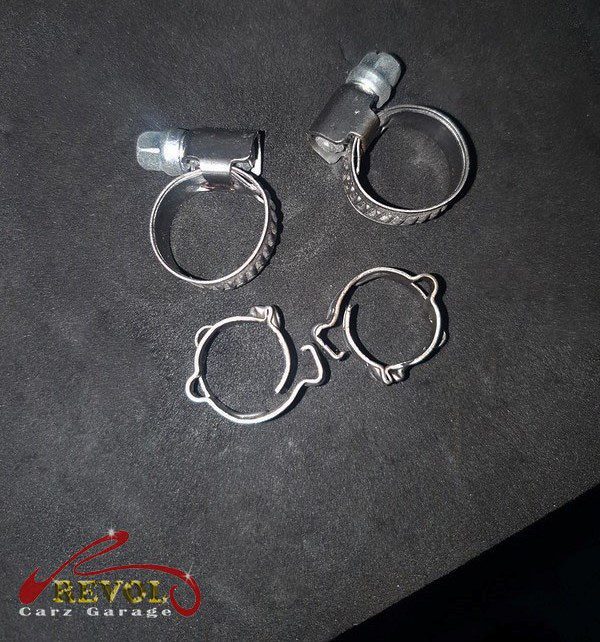 The old cracked fuel hose and worn clamps removed.