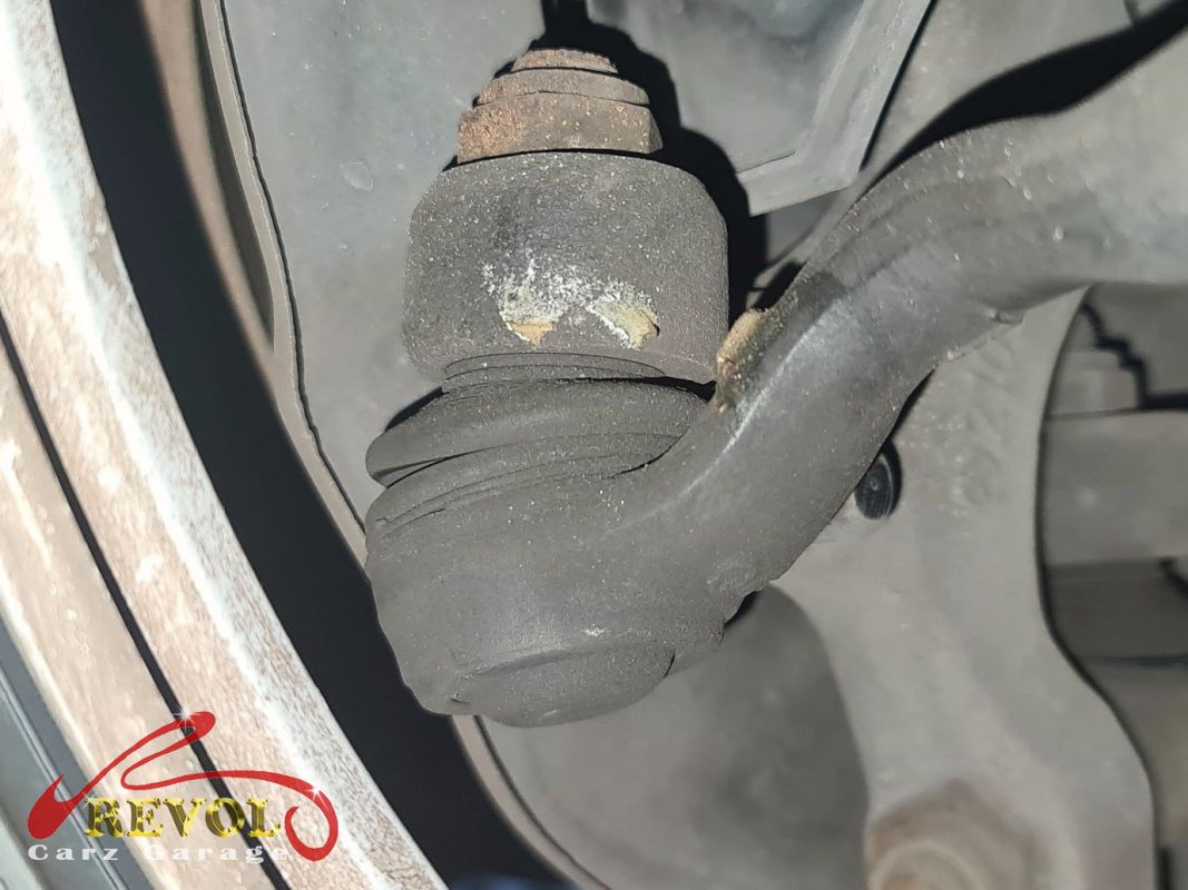 The worn anti-roll bar drop links with loose ball joints.