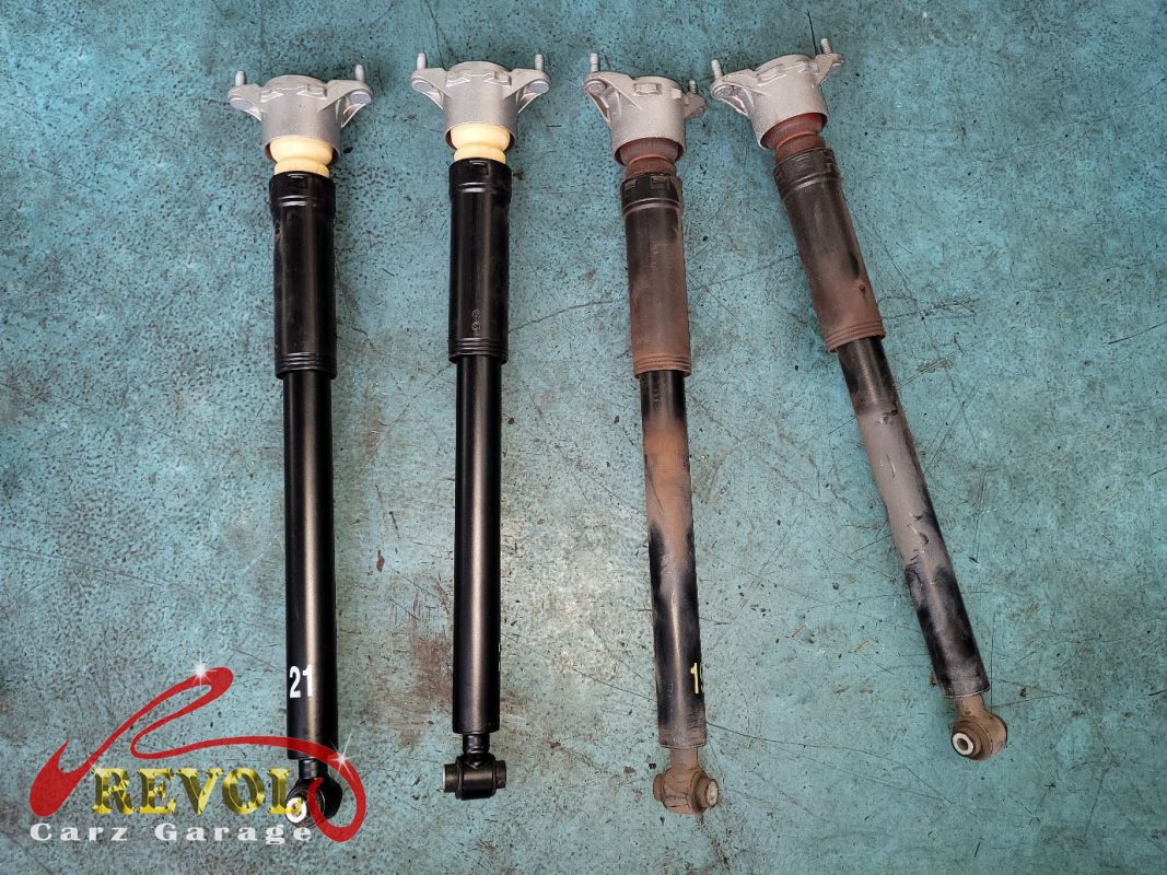 The old front struts removed alongside the new pair.