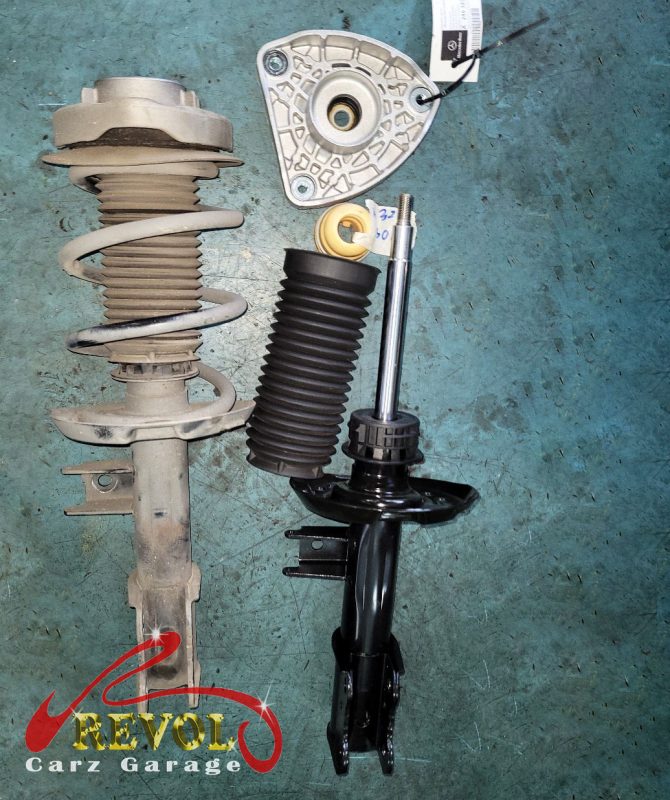 The old rear shocks removed alongside the new pair.