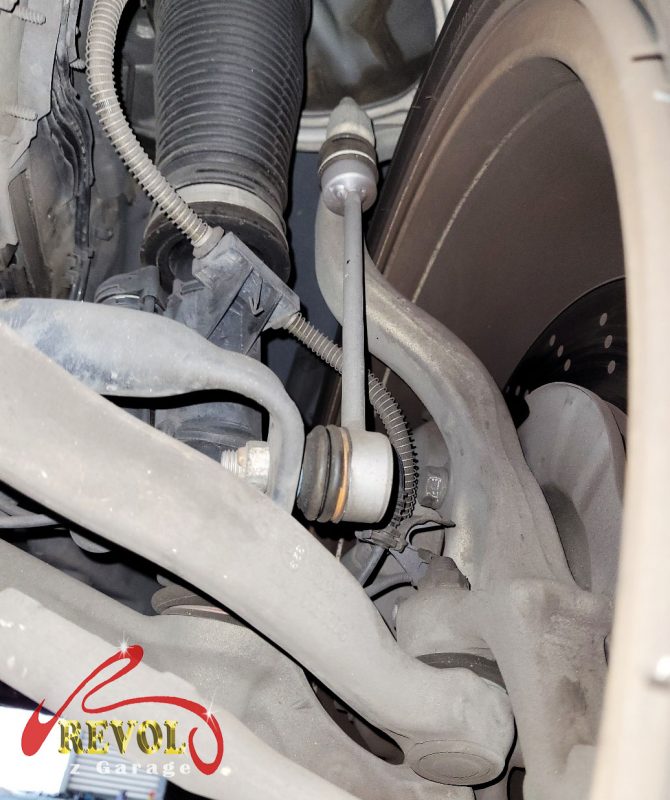 The worn front lower control arm bushings, cracked under load.