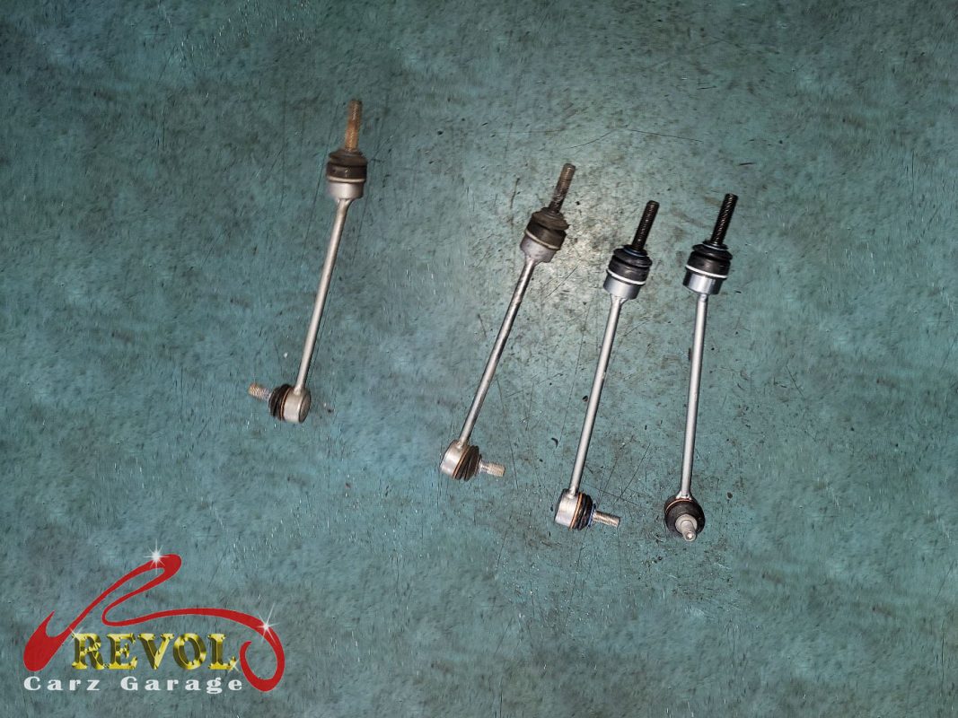 The worn anti-roll bar drop links with loose ball joints.
