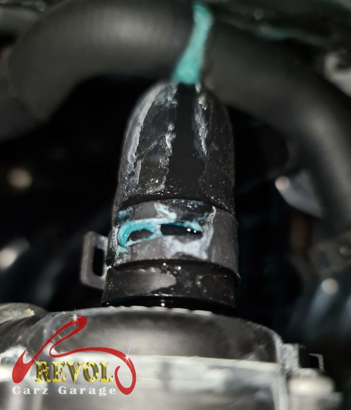 The old coolant pump and thermostat module removed showing the weeping seal.