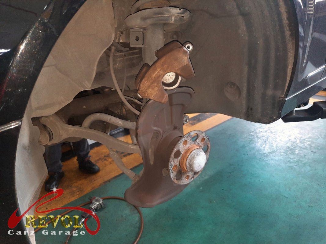 The old front discs removed alongside the new genuine set.