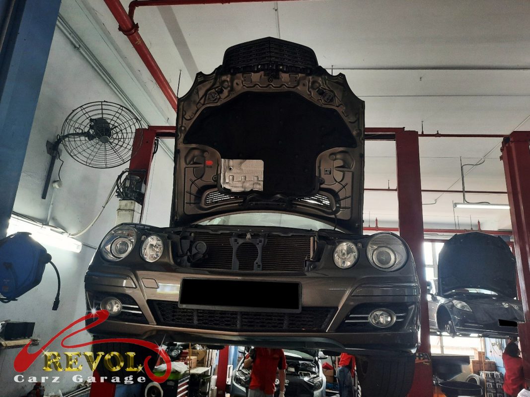 The worn rear shock absorber on the Mercedes-Benz E200, weeping and weak.