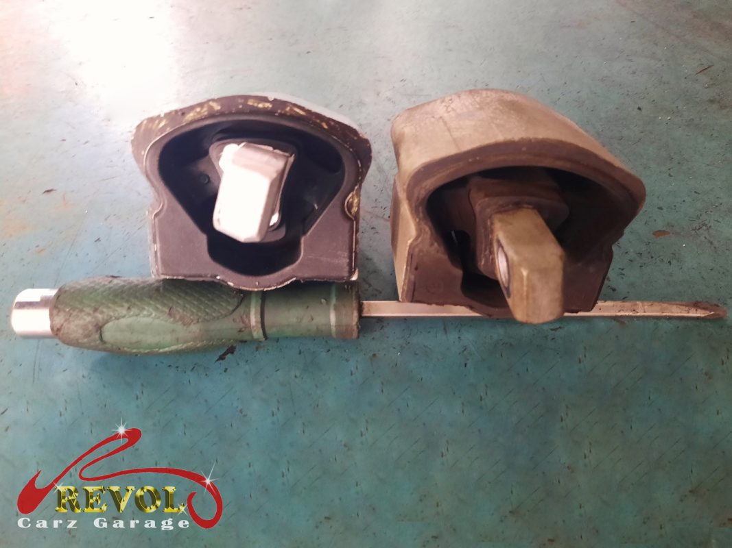The transmission mount removed showing the play under load.
