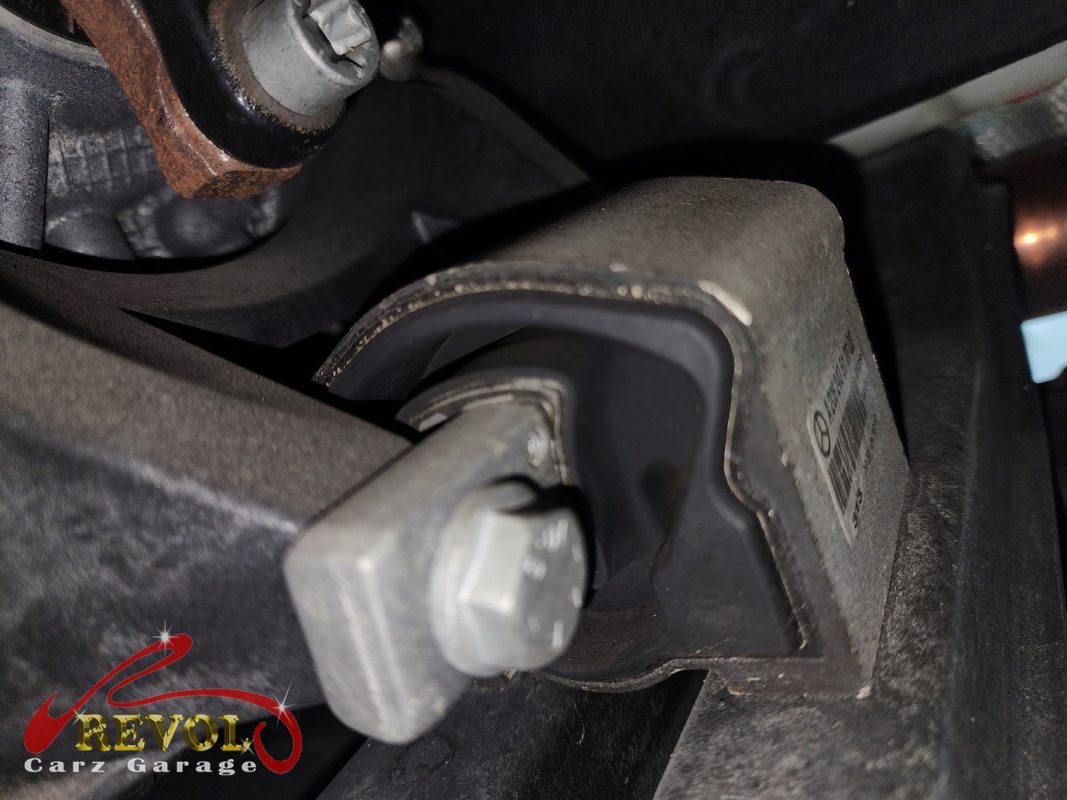 The worn engine mount with cracked and sunken rubber on the Mercedes-Benz GLC200.