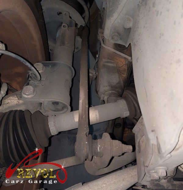 The old worn anti-roll bar links removed, ball joints loose.