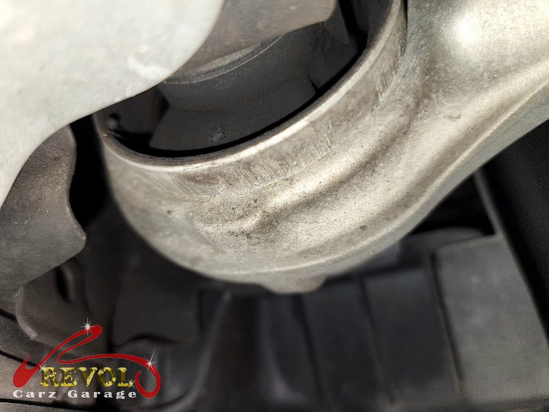 Both old front lower control arms removed alongside the new pair.