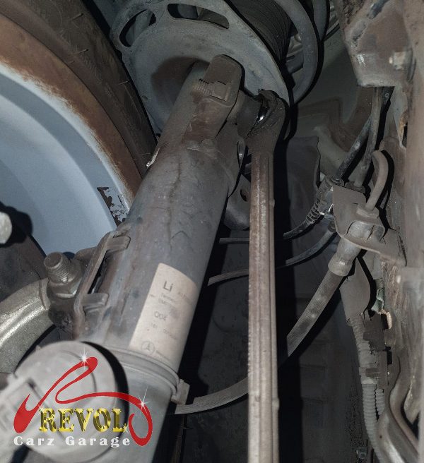 The old worn anti-roll bar link with cracked bushings removed.