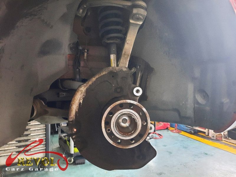 The front wheels spun and checked by hand on the Mercedes-Benz E200, the bearings rough with play.