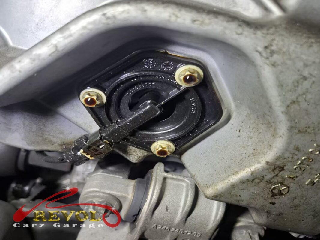 The oil level sensor bolted into the bottom of the engine sump.