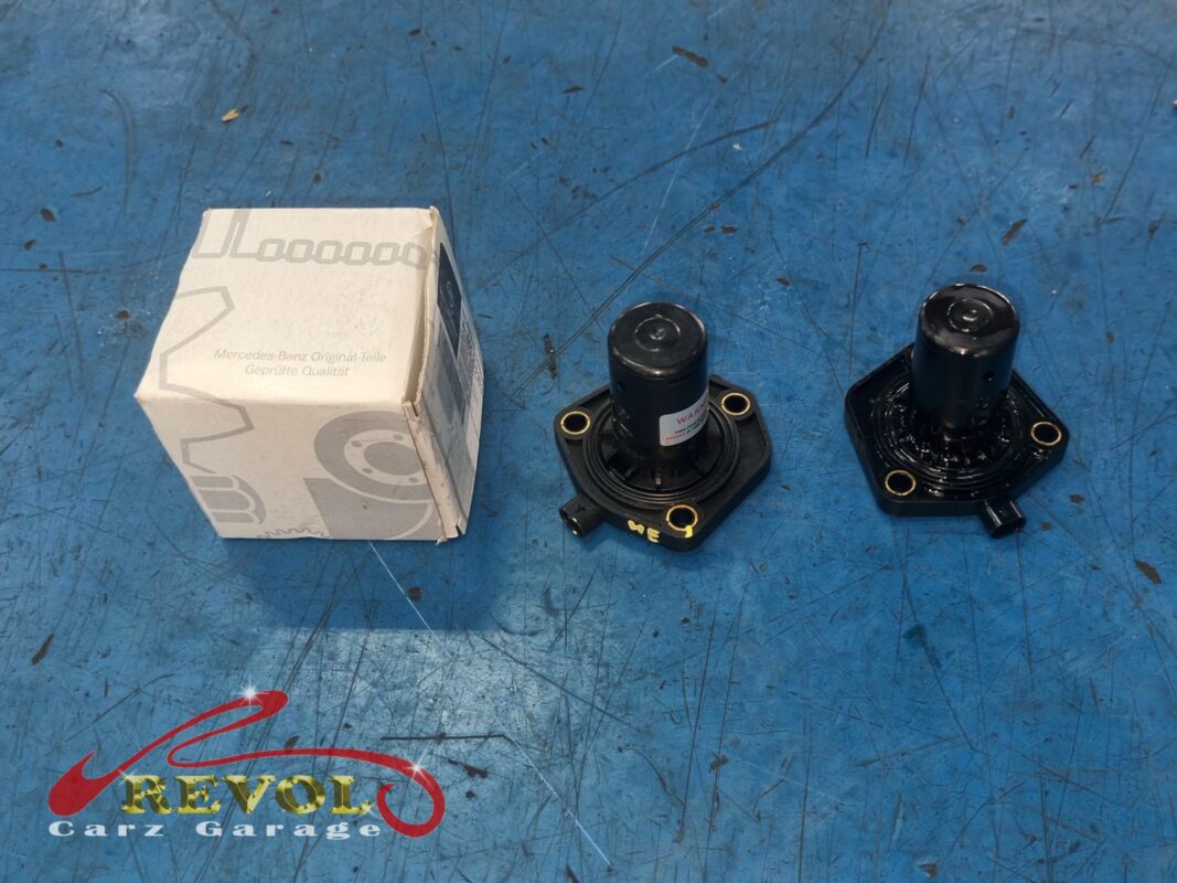 The old oil level sensor (right) beside the new Mercedes-spec replacement (left, in its box).
