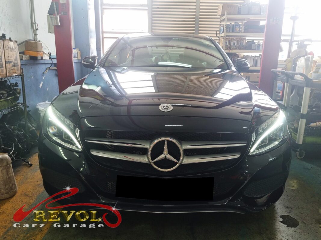 Mercedes-Benz C180 on the workshop lift for oil sump replacement.