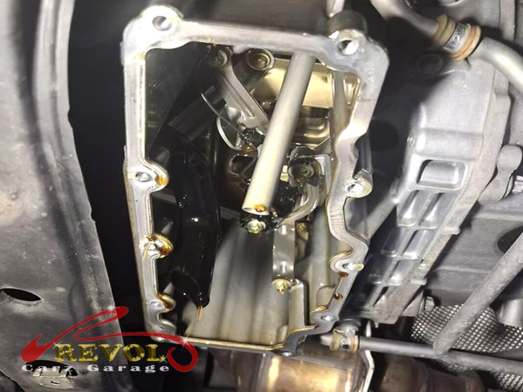 The lower sump pan off, looking up at the block and the oil pickup, the mating face exposed.