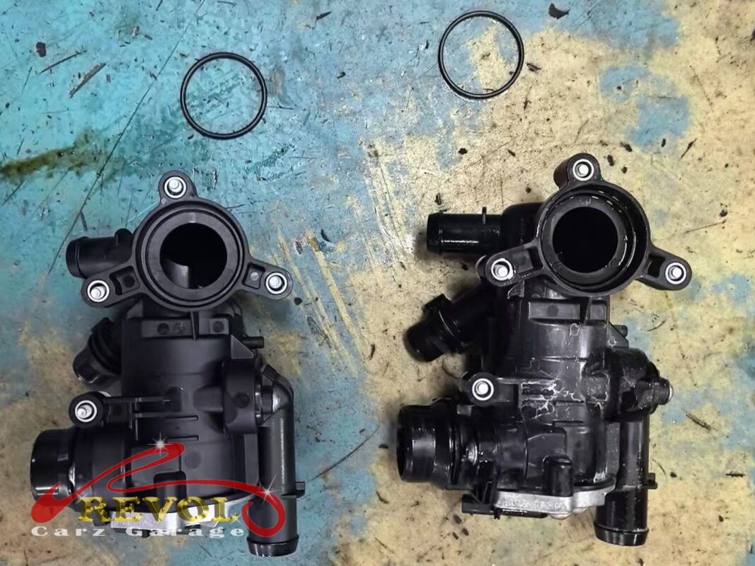 The new thermostat housing (left) beside the old unit removed (right), with fresh O-rings.