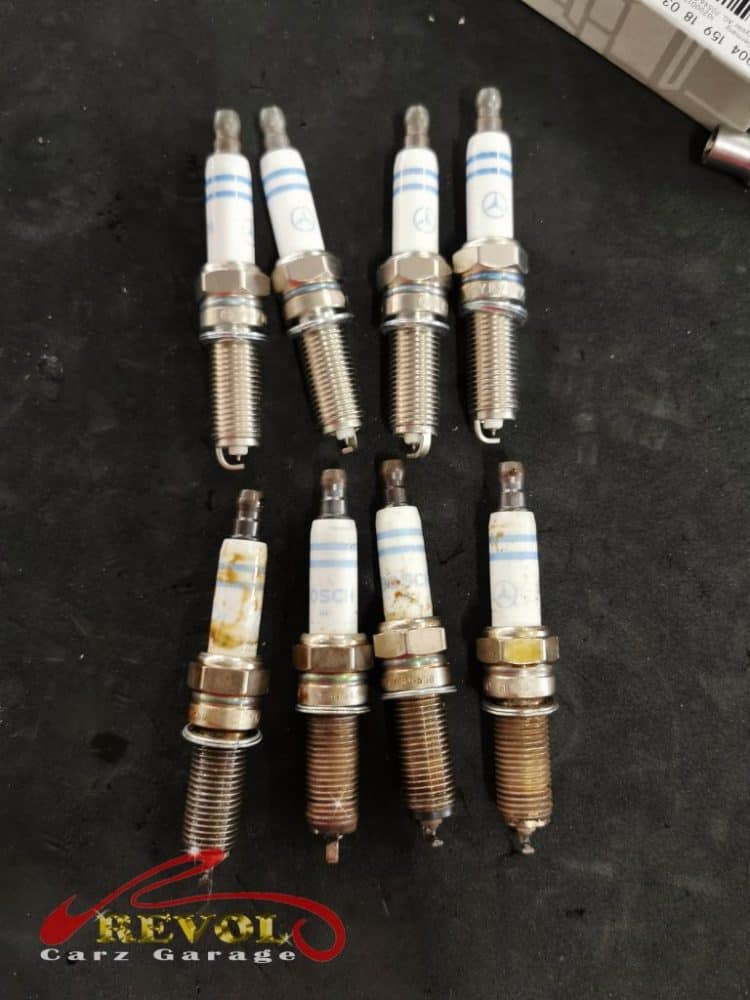The worn plug seals and the new genuine Mercedes-spec plugs and seals ready to fit.