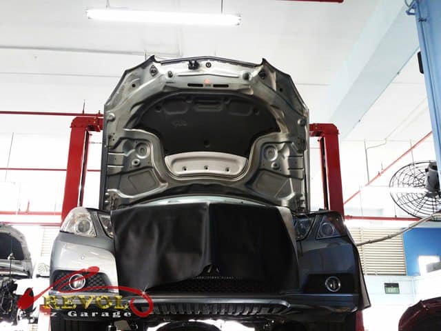 The Mercedes-Benz E250 lifted for inspection, the oil leak traced to the filter housing.