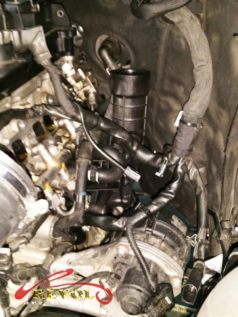 The worn oil filter housing weeping oil where it bolts to the engine.