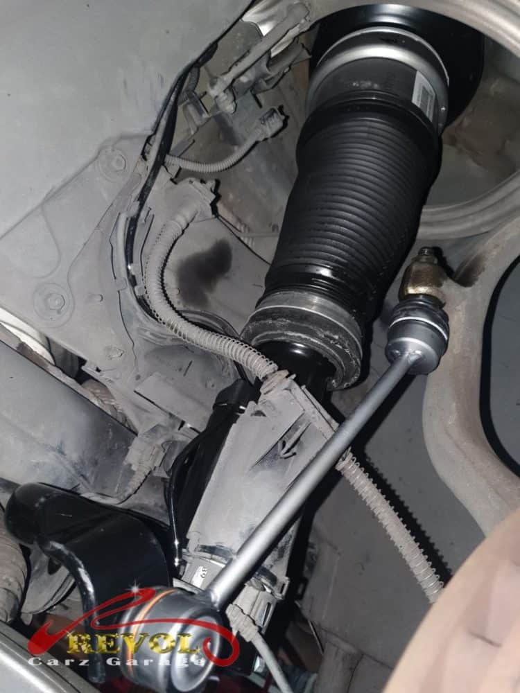 The worn front Airmatic air struts removed.