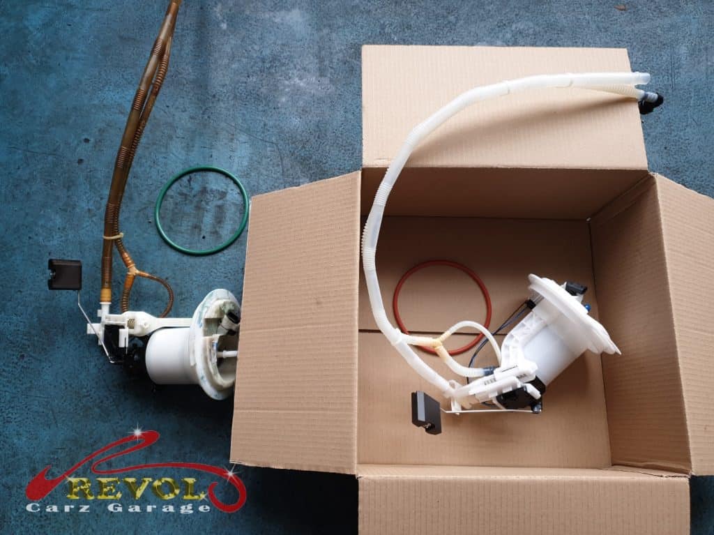 The worn fuel pump module removed, leaking fuel from its seals.