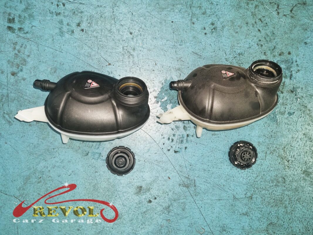 The new expansion tank and cap (left) beside the old cracked unit removed (right).