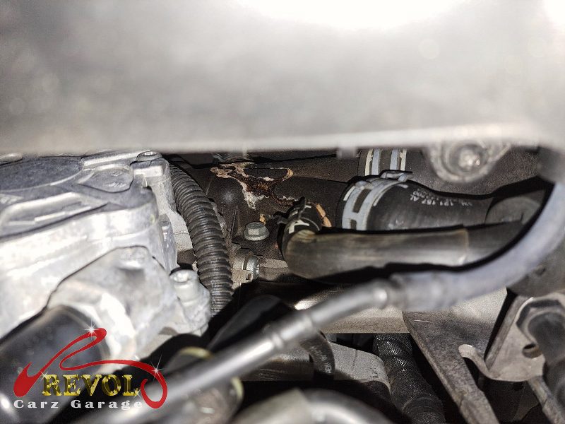 The old cracked cylinder head coolant bypass pipe and connector removed.