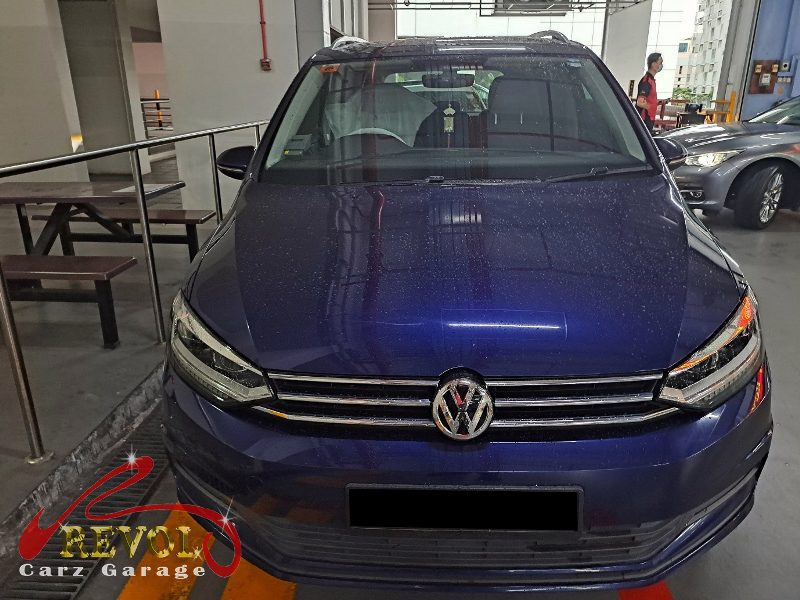 Volkswagen Touran parked at the workshop for scheduled maintenance.