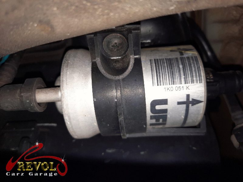 The old clogged fuel filter removed, loaded with trapped debris.